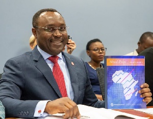 World Bank Africa Region Chief Economist, Albert Zeufack holding a copy of the African Pulse Report