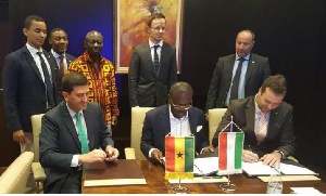 Dr. Siaw Agyapong (middle) and Mr Horvath (right) signing the MoU