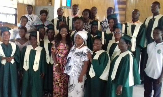 Esi, flanked by members of St Lawrence Catholic Church at Abura
