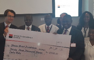 Francois Marchal, Deputy MD, SG Bank, presenting the cheque to Dr Lawrence Agyeman Sereboe