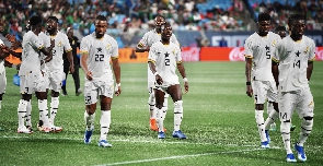 Black Stars players during first half break in game against Mexico | File photo