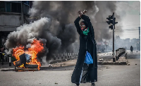 A protester reacts in front of a burning barricade in downtown Nairobi, Kenya, June 25, 2025
