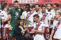 Afriyie Acquah and his Torino teammates on the rostrum celebrating their Eusebio Cup win