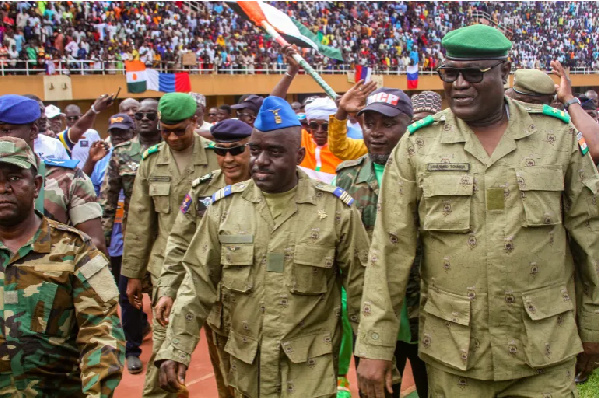 Members of a military council that staged a coup in Niger attend a rally at a stadium in Niamey