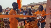 Nana Bepow I, Chief of Nyameyekrom assisted by Eric Osei to officially commission the renovated schl