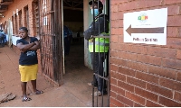 A woman waits outside a polling station in Harare on August 23, 2023