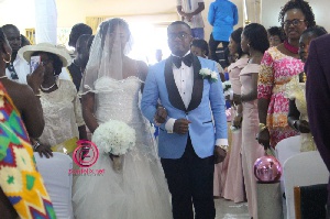 Michael Asumadu Adomako and his bride Dorcas Maame Asamoah walking down the aisle.