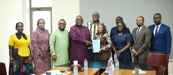 Chairman of the Committee, Larry Kwesi Jiagge presented the report to the Acting NIC Commissioner