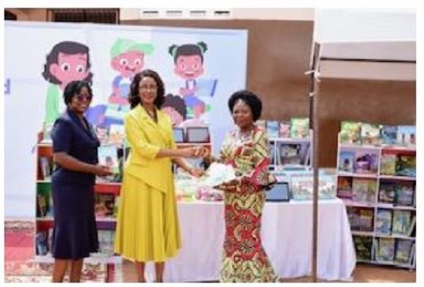 Angela Okai handing over some books