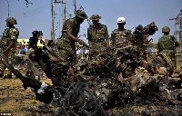 Security forces view the scene of a bomb explosion