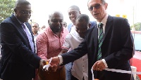 Bernard Le Goff (r) being assisted by Ebenezer Faulkner (l) to officially open the Westlands branch