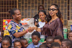 Former MP for Dome-Kwabenya, Adwoa Safo (in shades), presenting the items to officials of the home