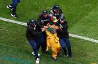 Security staff tackle a Senegal fan who invaded the pitch