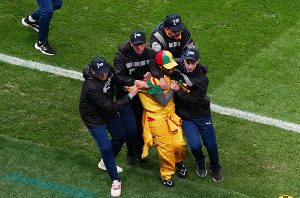 Security staff tackle a Senegal fan who invaded the pitch
