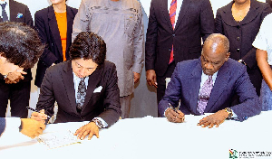 Education Minister, Haruna Iddrisu (right) and the Japanese representative signing the agreement