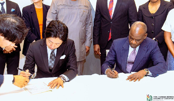 Education Minister, Haruna Iddrisu (right) and the Japanese representative signing the agreement