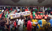 NDC members carry coffin covered with Nana Addo's posters.