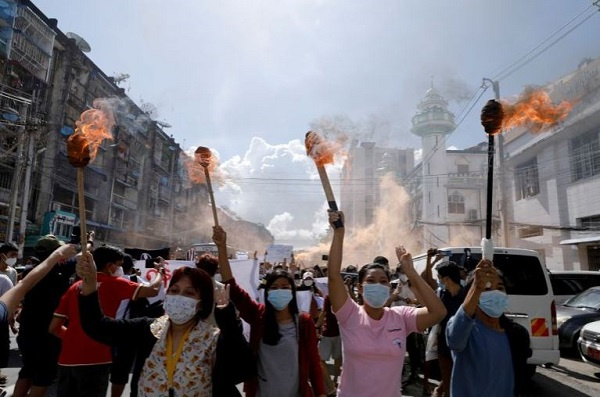 A group of women hold torches as they protest against the military coup in Yangon, Myanmar