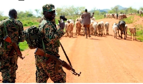 UPDF officers on Moroto – Kotido road in Napak District, Uganda escorting Karamojong herders