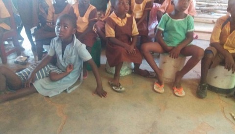 Pupils resort to discarded plastic buckets as desk in class