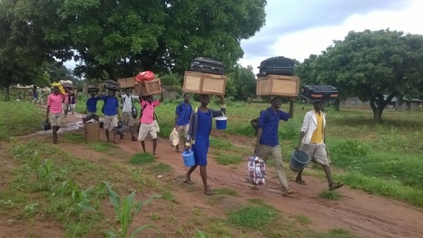 File photo: Some students leaving school with their belongings