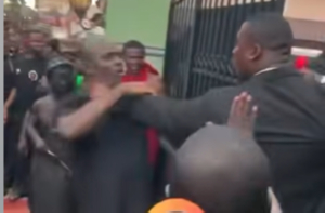 The bodyguard grabbed the man by the neck and delivered several heavy punches to him