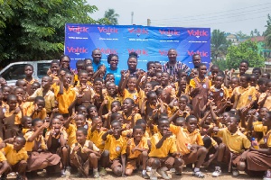 Some officials of Voltic Ghana in a group photograph with some of the pupils
