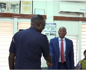 Mr. Miicheal Luguje (R), with the Tema Regional Police Commander, DCOP Nana Asomah (L)