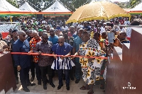 President Akufo-Addo being aided by Asenso-Boakye to inaugurate the library