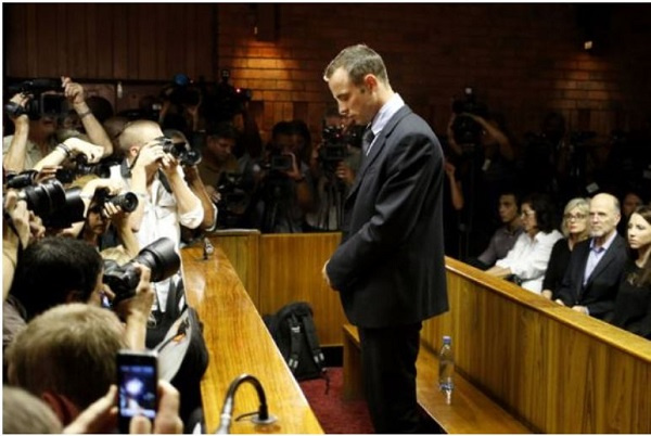 Oscar Pistorius stands at the dock before the start of proceedings