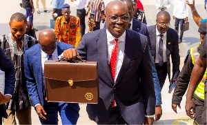 Minister of Finance, Dr. Cassiel Ato Forson with his brown bag