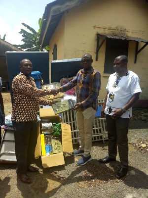 Hon Gilbert Ken Asmah donating medical equipment to Emmanuel Affelkum on behalf of  Mahamo clinic