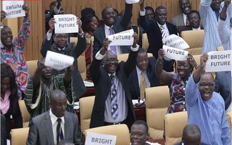 MPs in Parliament holding placards