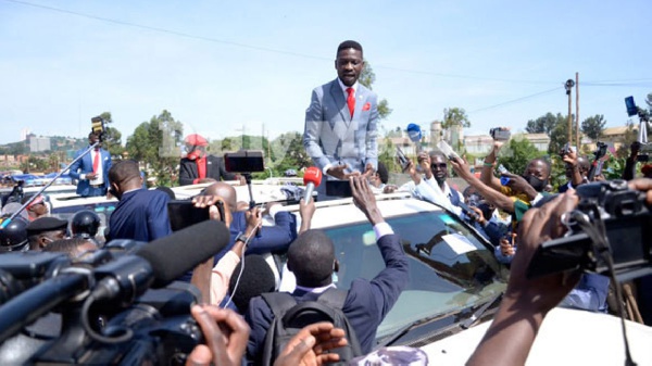 Presidential hopeful Mr Robert Kyagulanyi flanked by press corps and his supporters