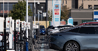 Electric vehicle charging stations are seen in Beijing, China, 11 October 2024