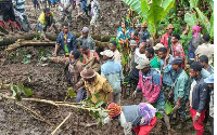 Residents search for the bodies of mudslide victims in the Gacho Baba district of the Gamo