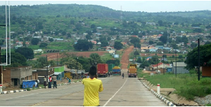 Trucks park at the Oraba border point in Koboko. Across the valley is Kaya town in South Sudan