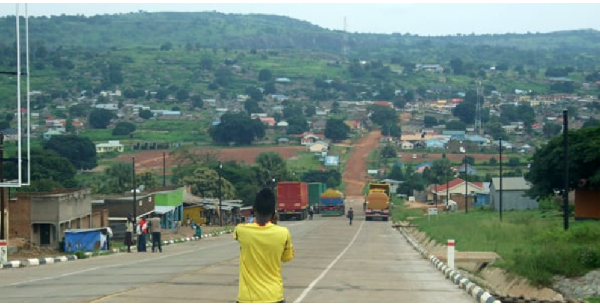 Trucks park at the Oraba border point in Koboko. Across the valley is Kaya town in South Sudan