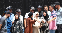 People gathered outside the orphanage after the fire