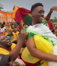 Ghanaian Fans carrying a Nigerian fan on their shoulders