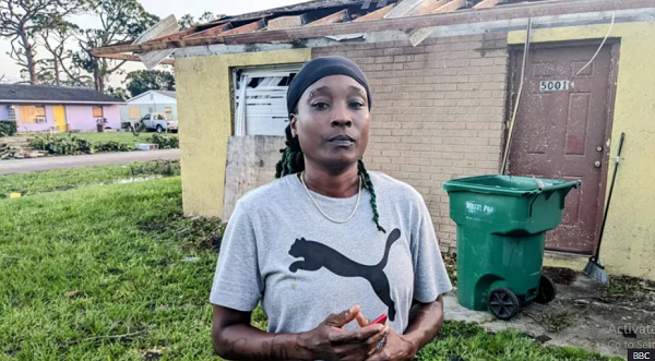 Crystal Coleman stands in front of the ruins of her home in south Florida