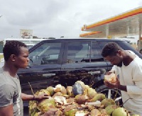 Sarkodie buying coconut by the road side