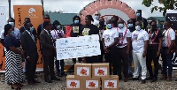 Anglogold Ashanti presenting a cheque and some items to the Kumasi Center for Collaborative Research