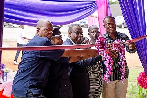 Elders of the community and some officials cutting the tape