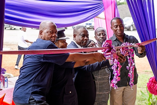 Elders of the community and some officials cutting the tape