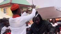 Prophet Ogyaba (in white attire) spraying cash on Ajagurajah (in black attire)