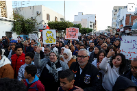 People march on the 15th anniversary of the 2011 uprising to protest over pollution