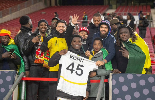 Black Stars defender, Derrick Kohn taking a picture with fans after the Germany game