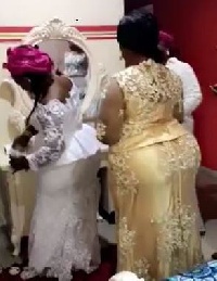 The lady in white (L) seen pouring out the 'akpeteshie' for Rev. Owusu Bempah