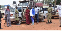 Ms Susan Namuganza (in maroon dress) at Kamuli Central Police Station on Tues. following her arrest